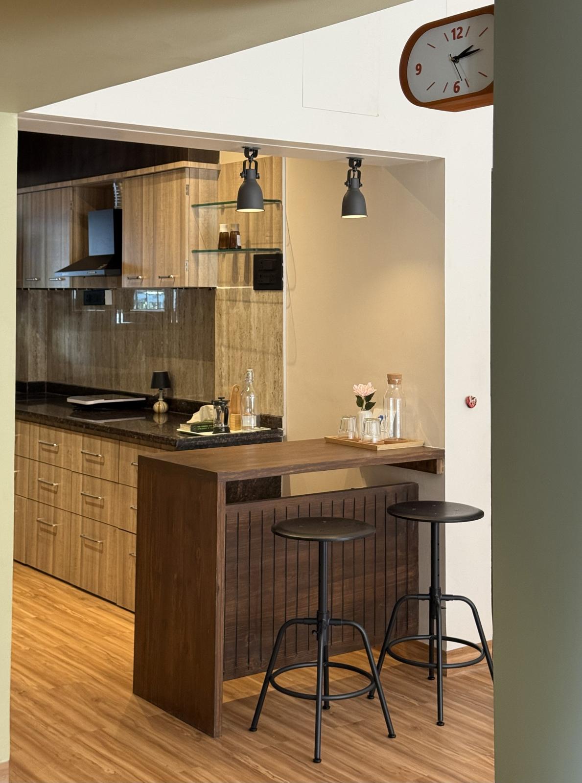 Walnut breakfast bar with two black stools